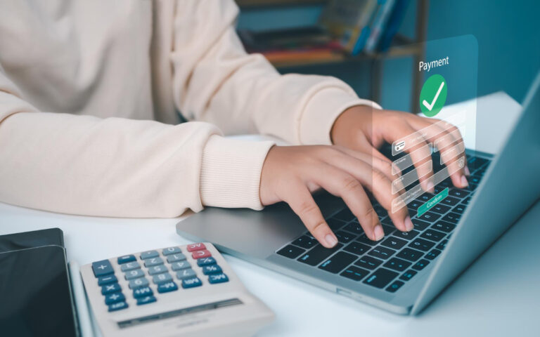 Accounts payable automation software for Singapore SMEs with digital payment processing on a laptop.