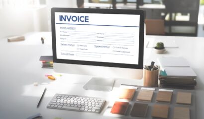 Online invoice processing software displayed on a desktop computer for automated invoice management.
