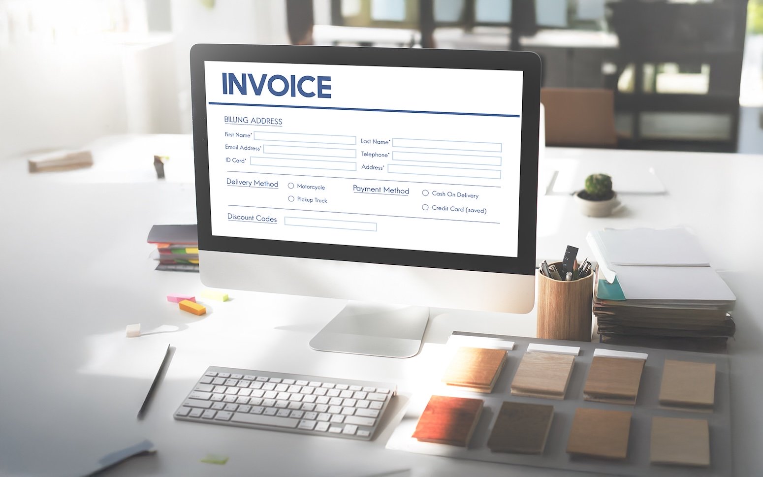 Online invoice processing software displayed on a desktop computer for automated invoice management.
